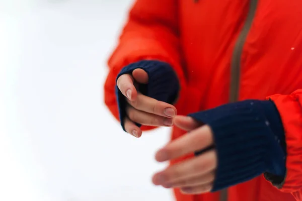 Woman  hands in orange jacket