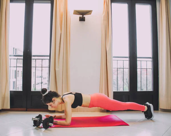 Young Woman Exercising Home Mat Dumbbells — стоковое фото