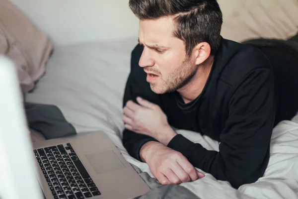 Young Man Looks Disappointed Angry Looking Laptop Bed - Stock-foto