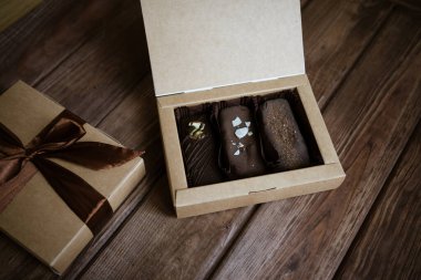 Tahta bir arka planda üç çikolata çubuğu.