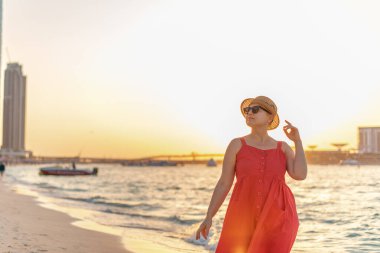 romantic view of a woman on the beach with beautiful sunset view