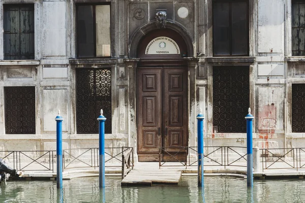 Waterfront property with double wooden door in Venice Italy