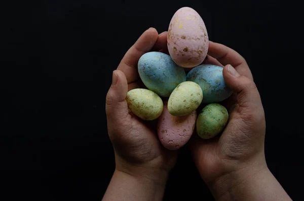 colored Easter eggs in hands, close-up