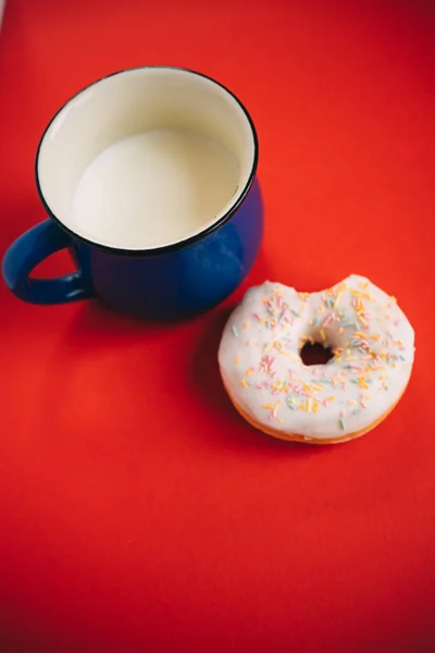 Bitten Donut Glaze Blue Cup Milk Red Background — Stock Photo, Image