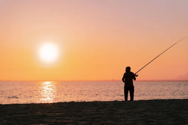 Silhouette Man Fishing Waves Beach Sunset Stock Photo