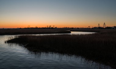 sunset over the marsh charleston bridge clipart