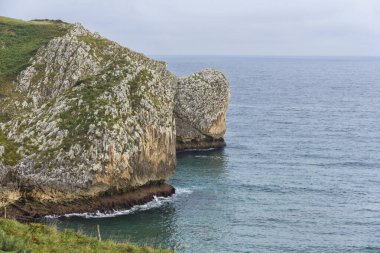 Bulutlu bir günde Cantabria sahilinin yanındaki uçurumlar