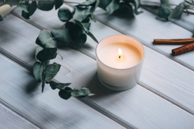 Mum, okaliptüs, beyaz ahşap arka planda tarçın.