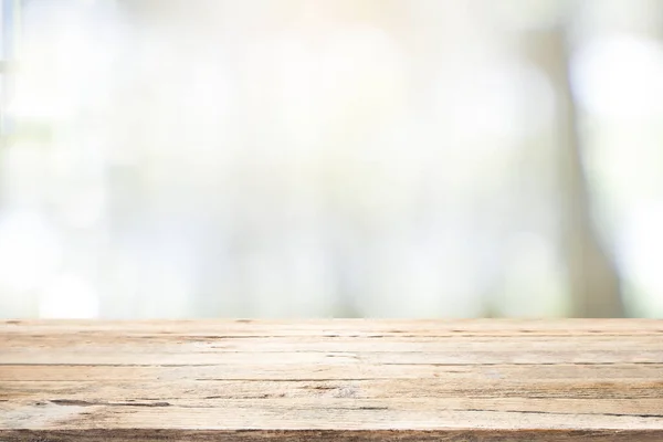 Empty wooden table for present product on coffee shop blur backg