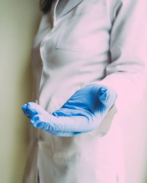 doctor in blue gown and gloves in hospital