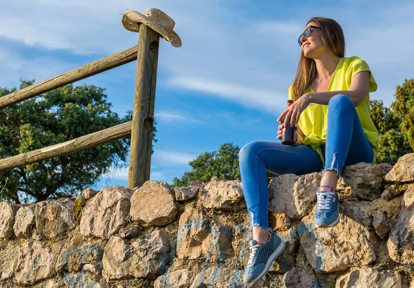 Woman Sitting Drinking Beer While Watching The Sunset. Nature.Person