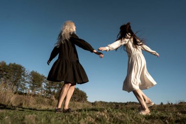 Gün batımında tarlada yatan iki güzel ikiz kız.