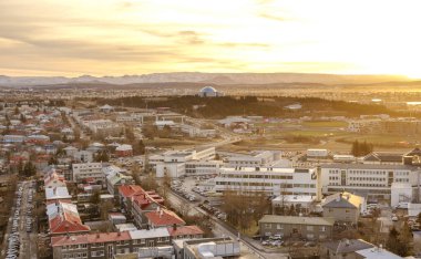 View over Reykjavik in winter.  The winter sun barely reaches over the horizon at this time of year. clipart