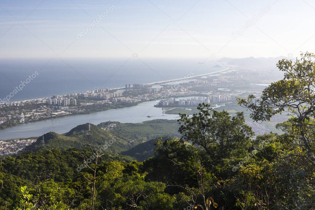 Beautiful view from green rainforest mountain to city and ocean