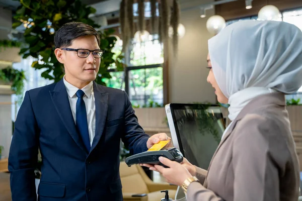 Business people pay by credit card,Businessman using credit card for payment to receptionist at restaurant, cashless technology and credit card payment concept.