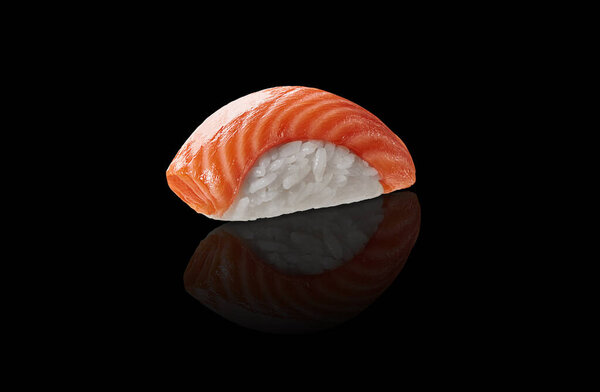 Closeup of one piece of traditional Japanese nigiri sushi with raw salmon isolated on black background with reflection. Authentic cuisine concept