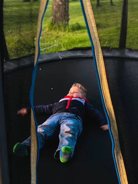 Boy Lies Trampoline — Stock Photo, Image