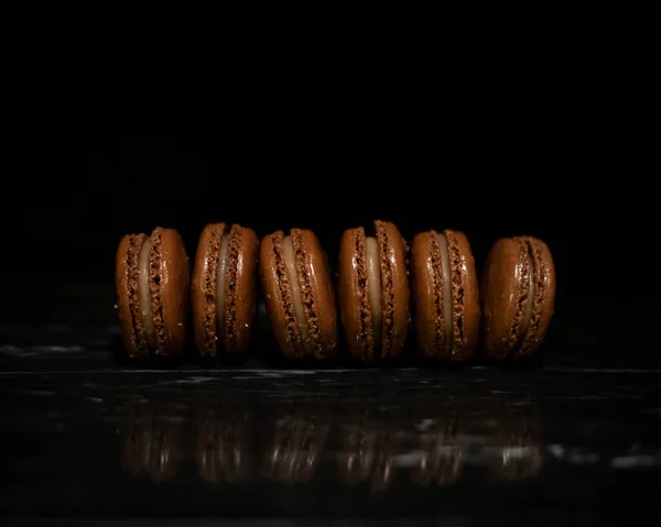 Linie Von Gesalzenen Karamell Macarons Auf Schwarzem Marmor — Stockfoto