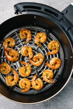 Golden shrimp cooked in an air fryer clipart