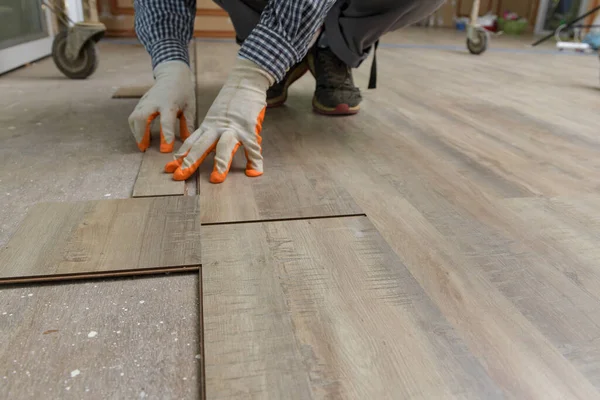 Home tile improvement - handyman with level.Tiler works with flooring