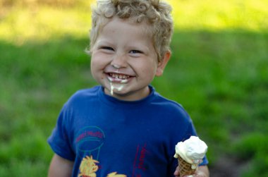 boy 2 years old with ice cream in his hand