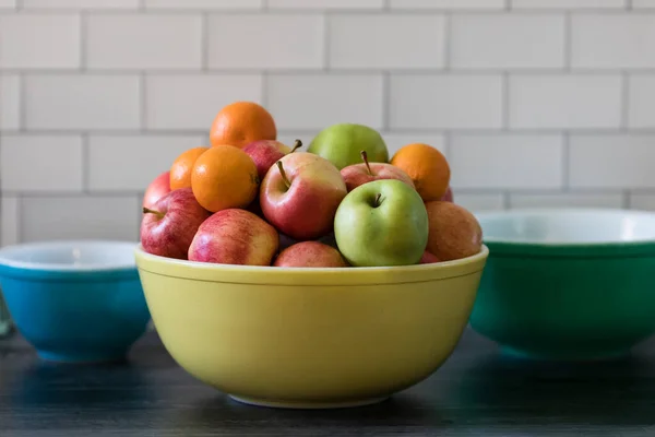 Apples and oranges in vintage fruit bowl subway tile kitchen