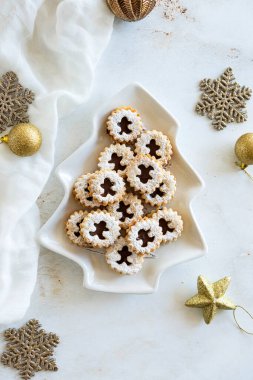 Festive Linzer cookies on shaped plate