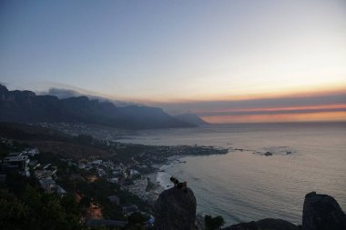 Person Watching Sunset over Camps Bay and the Twelve Apostles