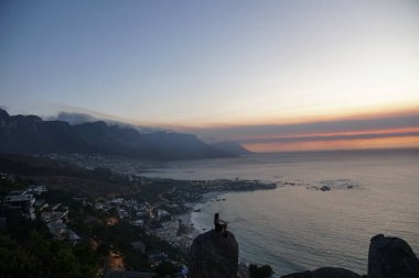 Person Watching Sunset over Camps Bay and the Twelve Apostles