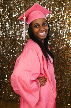 Happy and accomplished black female teen graduating girl