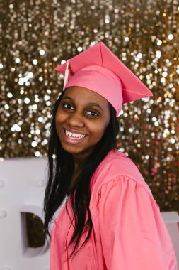 Close up of beautiful black teenage girl in graduation cap