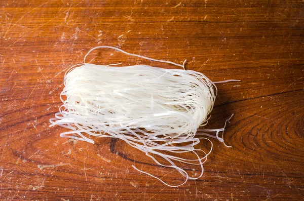 Raw noodle on wooden table — Stock Photo, Image