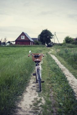 vintage bike on the country road.summer background clipart