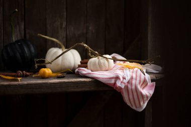 autumn background with pumpkins on an old rustic bench. clipart