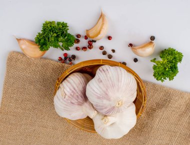 Sacks arka planında sarımsak, biber ve maydanoz.