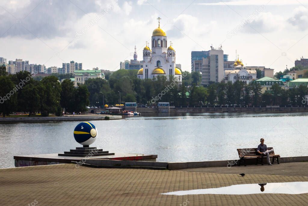 Yekaterinburg. City pond embankment. View of the temple on blood and pokeball on a sunny summer day