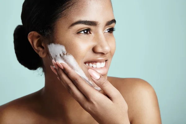 Woman with foam on cheek — Stock Photo, Image