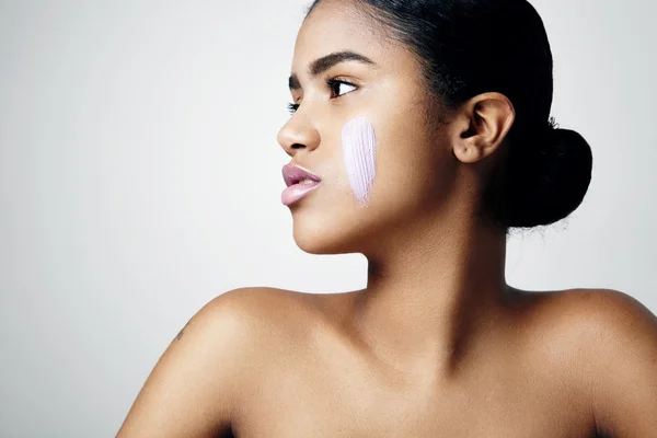 Woman with cream on cheek — Stock Photo, Image