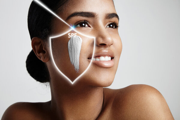 Woman with sun protection cream on cheek