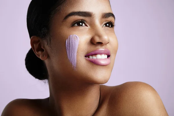 Woman with cream on cheek — Stock Photo, Image