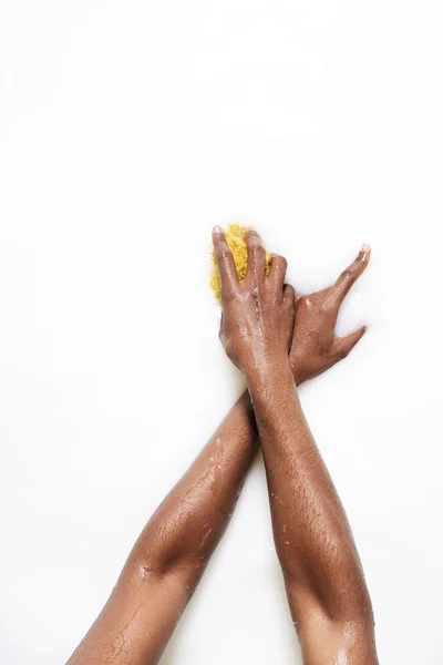 Female hands holding yellow sponge — Stock Photo, Image