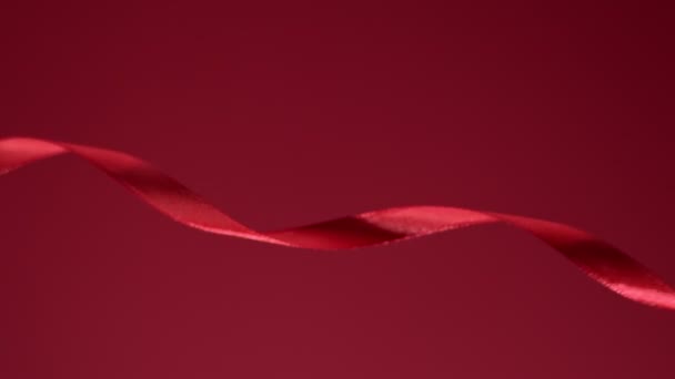 Ruby fabric satin glossy strip moving in front of a matte backdrop. 4k high quality video footage. — 图库视频影像