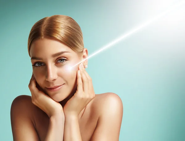 Woman with  laser on her cheek — Stock Photo, Image