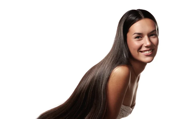 Kvinna med långa glänsande hår — Stockfoto