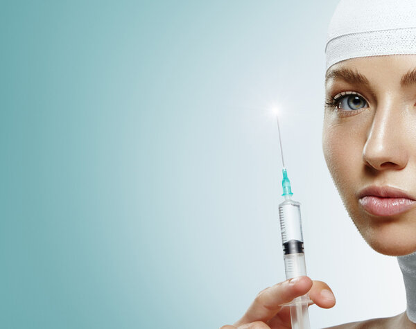 Woman holding botox injection