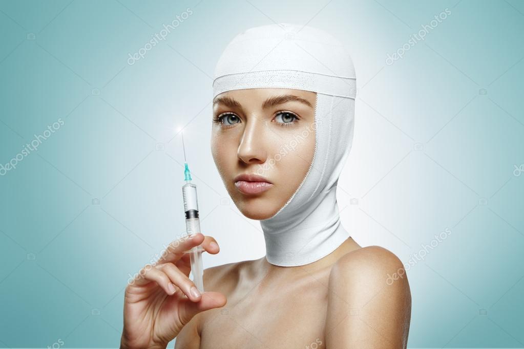 Woman holding botox injection