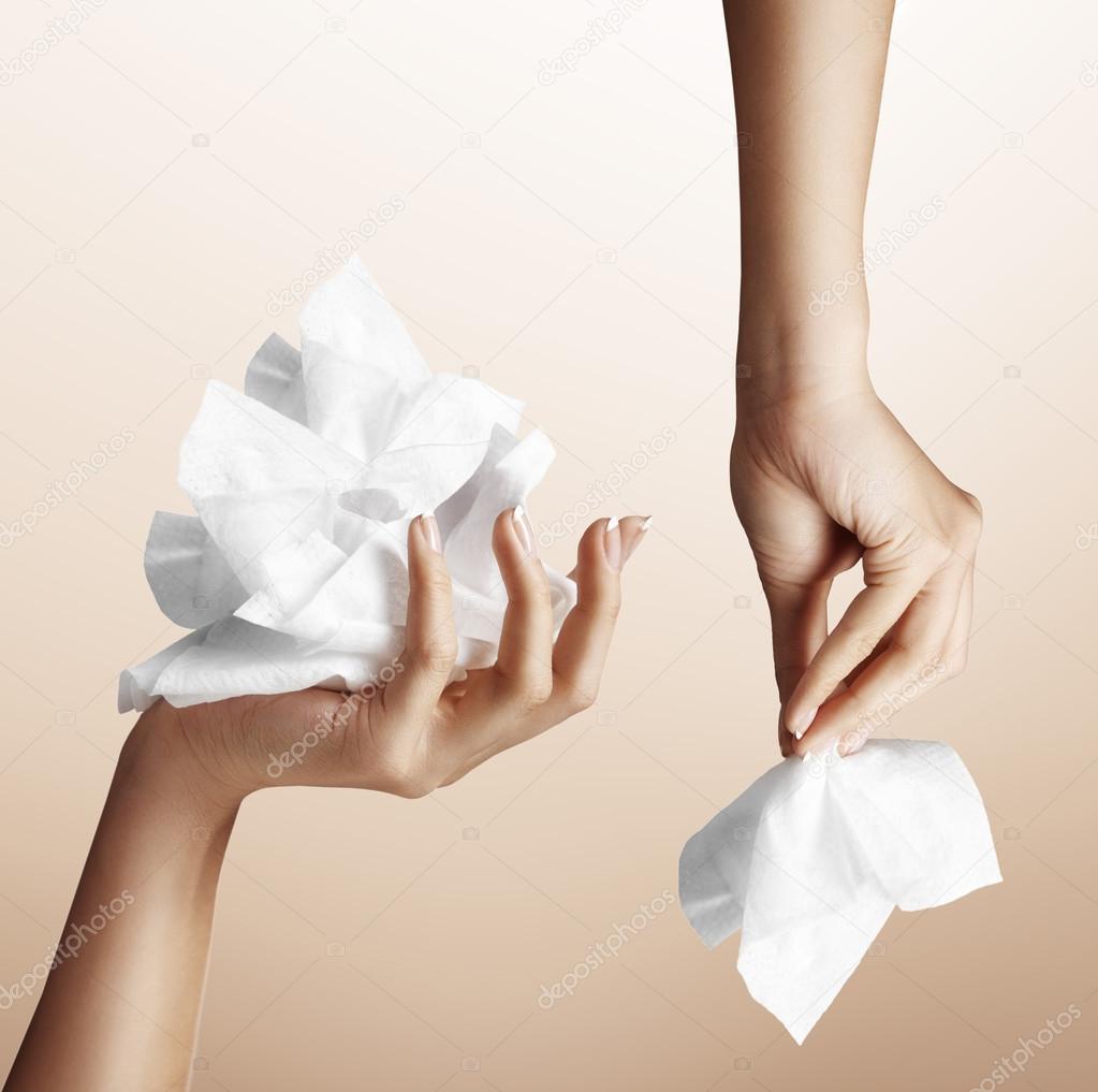 Hand with makeup remover wipes