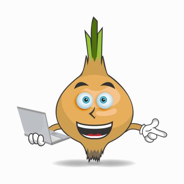 Sağ elinde dizüstü bilgisayarı olan soğan maskotu karakter..