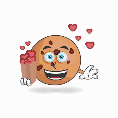 Kurabiye maskotu bir aşk simgesi tutuyor..