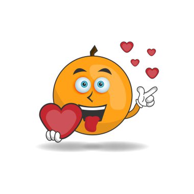 Turuncu maskotun elinde aşk simgesi var..